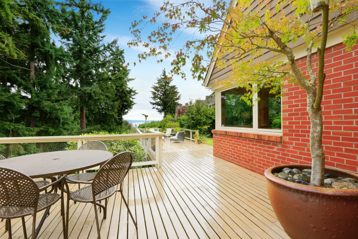 Patio and sitting area on spacious walkout deck. Brick house exterior
