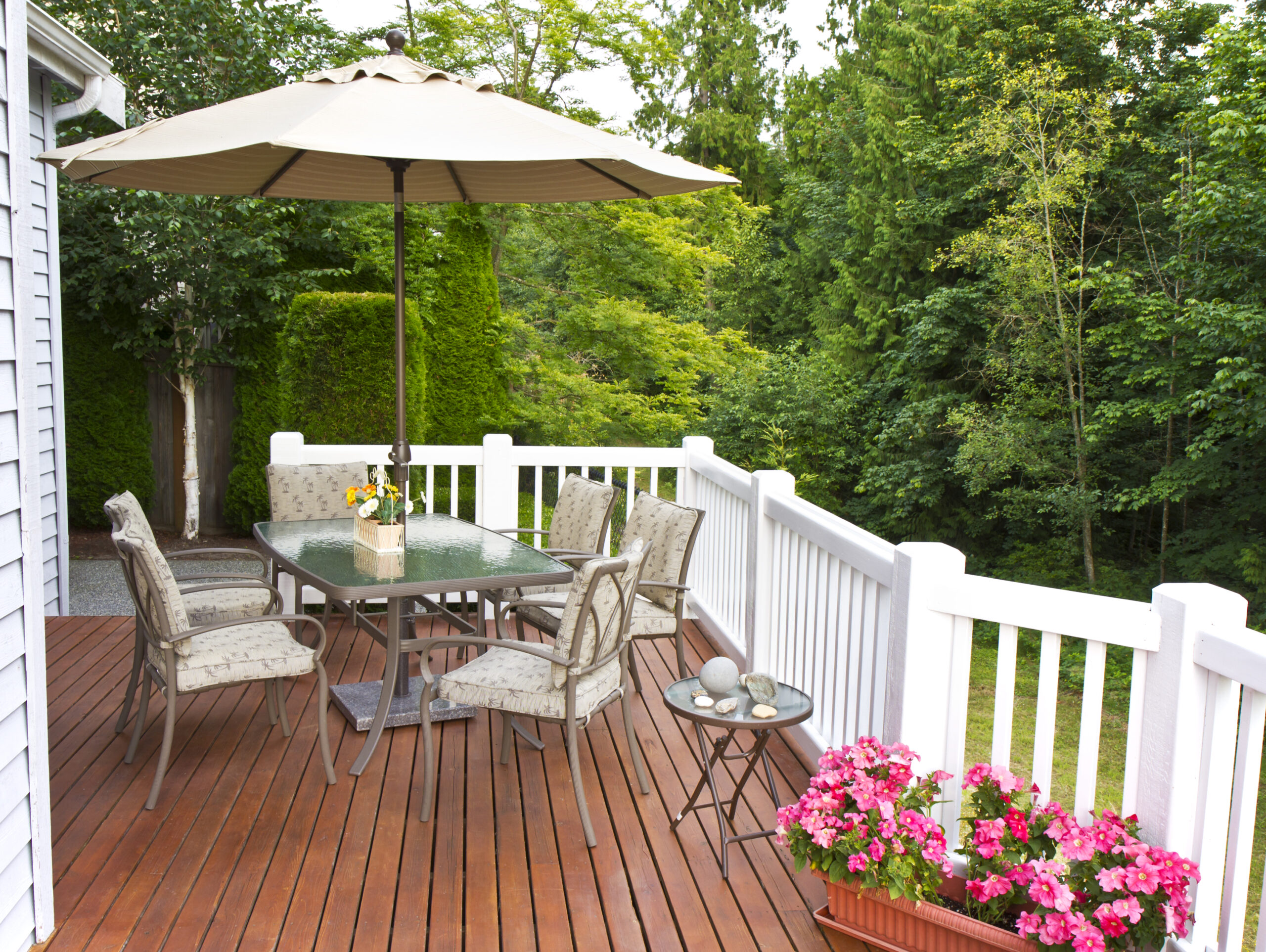 Outdoor patio setup on cedar wood deck  with trees in background